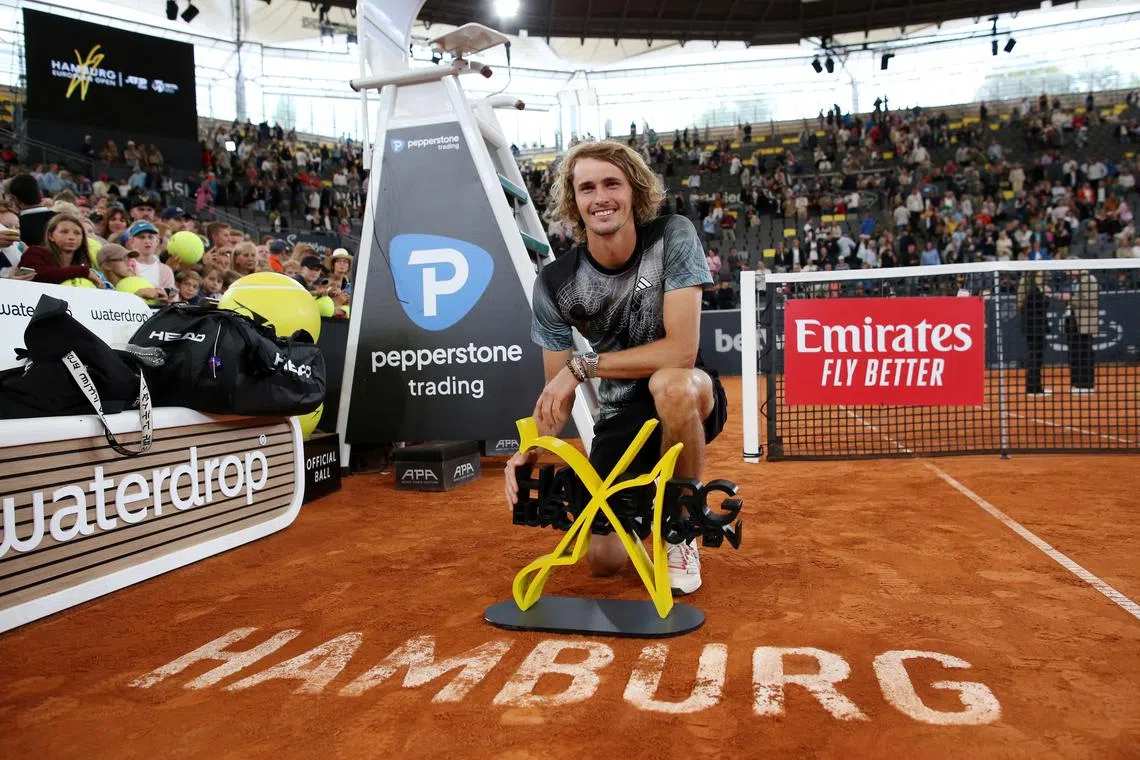 Germany's Alexander Zverev celebrates with a trophy after winning the final against Serbia's Laslo Djere.