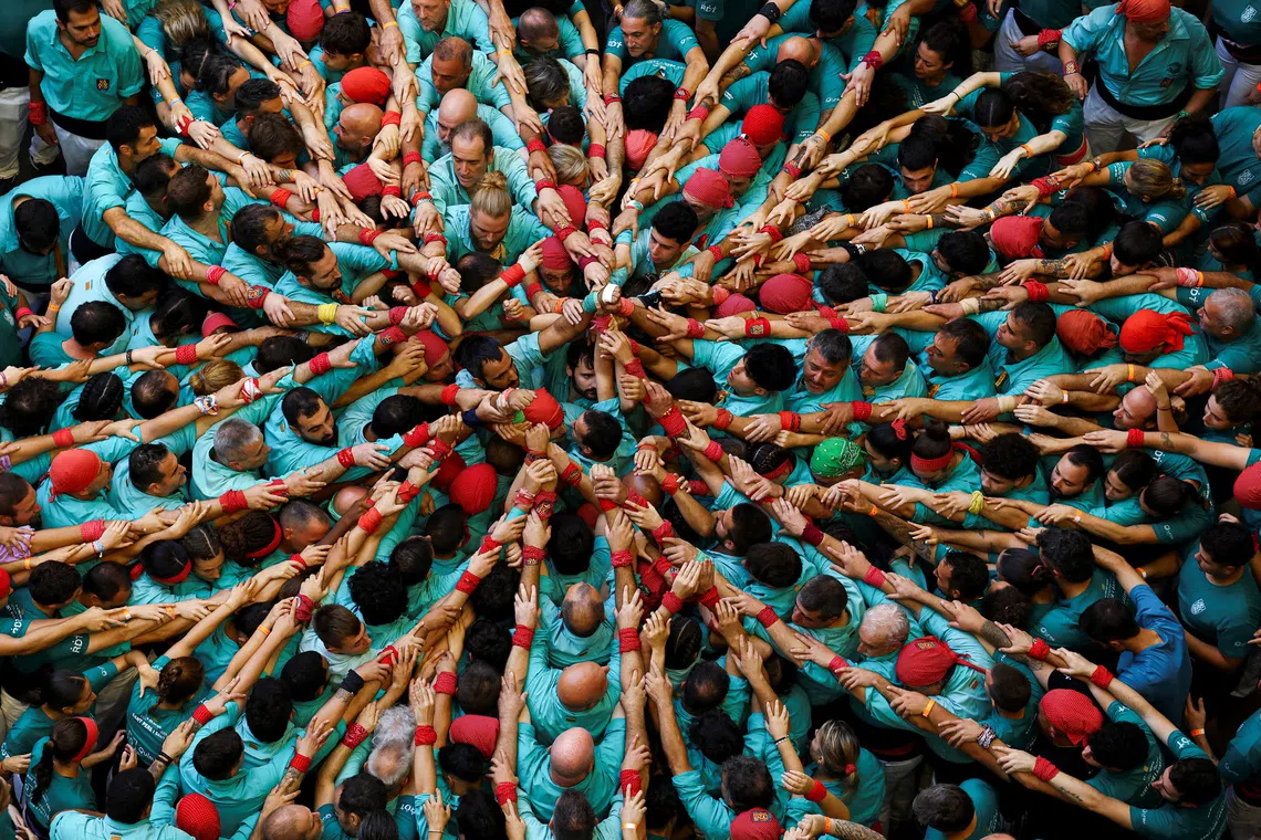 Members of "Colla Castellera de Sant Pere i Sant Pau" start to form a human tower called a "castell" in Catalan, during a biannual competition in Tarragona, Spain, October 4, 2026. REUTERS/Albert Gea TPX IMAGES OF THE DAY