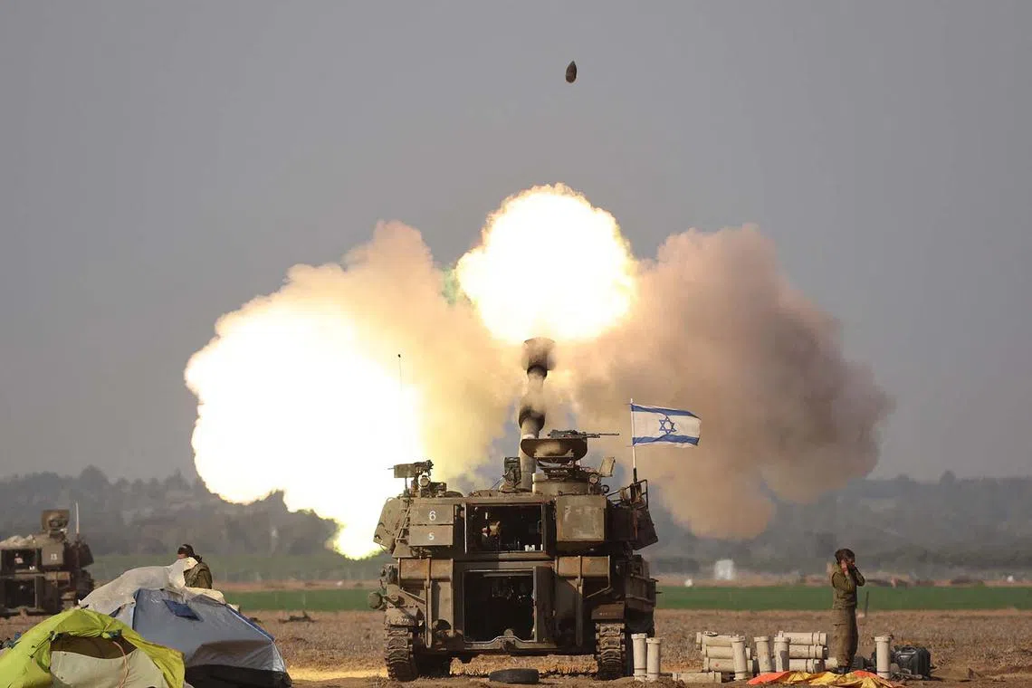 TOPSHOT - Israeli forces shell the Gaza Strip from the border area in southern Israel on December 12, 2023 amid ongoing battles with the Palestinian Hamas movement. Israel pressed on with its bombing of Gaza on December 12 after saying its campaign to destroy Hamas has left the Palestinian militant group on the "the verge of dissolution". (Photo by JACK GUEZ / AFP)
