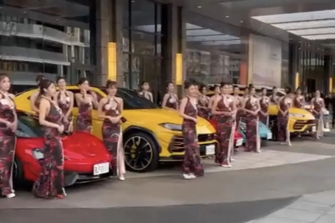 Footage on social media showed scores of hostesses lining up to welcome the Bamboo Union members alongside luxury supercars.