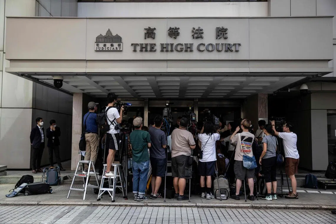Journalists and members of the press stand outside the High Court on July 28, 2023, when a Hong Kong judge denied a government request for an injunction banning Glory to Hong Kong.