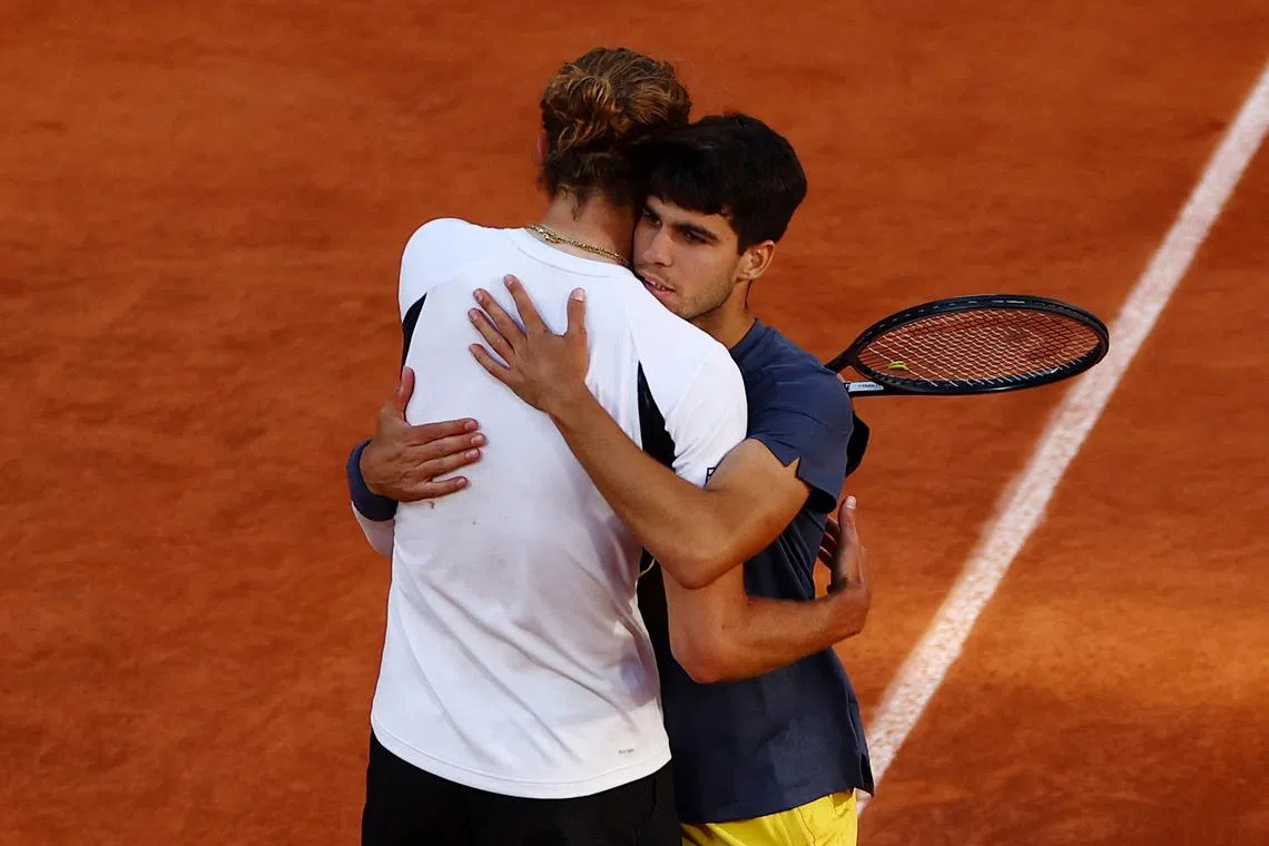 Tennis - French Open - Roland Garros, Paris, France - June 9, 2024 Spain's Carlos Alcaraz with Germany's Alexander Zverev after winning the men's singles final REUTERS/Lisi Niesner