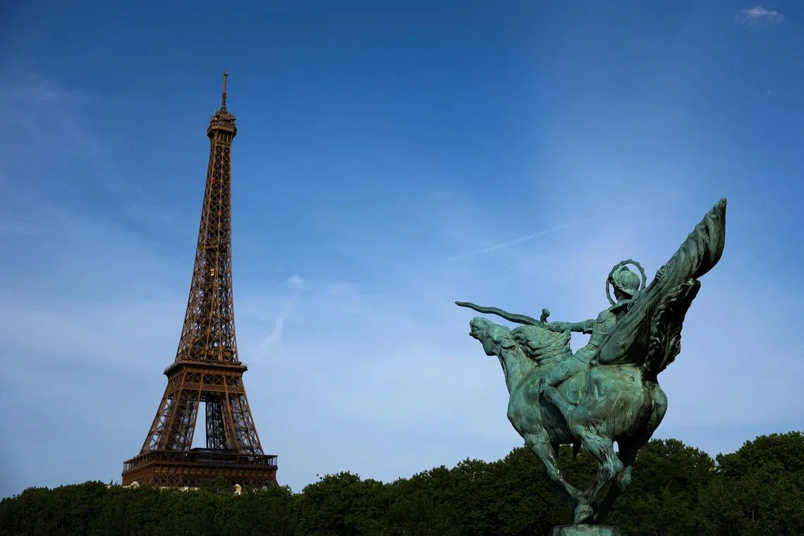 Two men wearing balaclavas scaled the 330m-tall Eiffel Tower before dawn, before jumping off with parachutes.