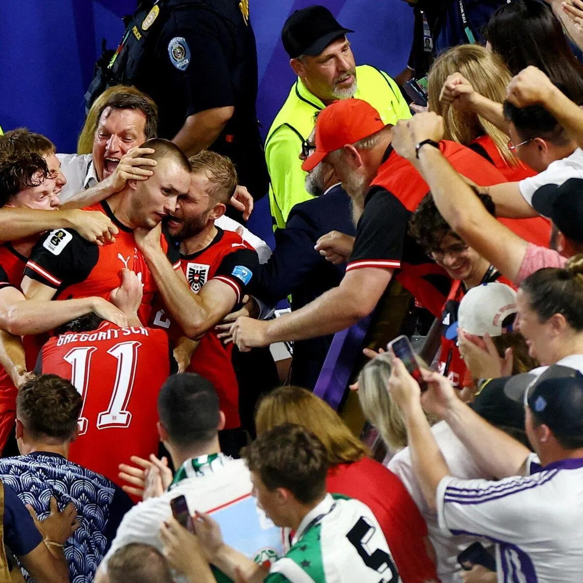 Austria’s Sasa Kalajdzic celebrates scoring their third goal with teammates and fans during their 3-3 World Cup draw with Algeria on June 27.