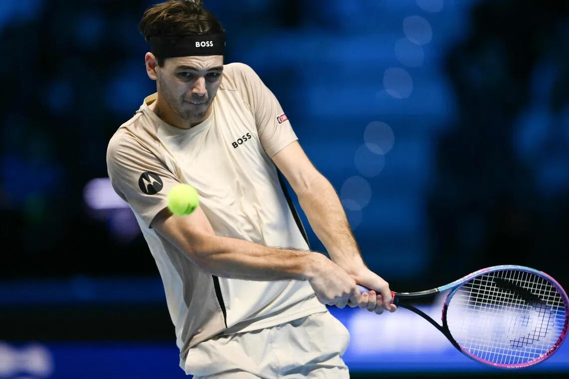 Taylor Fritz playing a backhand return to Italy's Lorenzo Musetti during the ATP Finals in Turin on Nov 10.