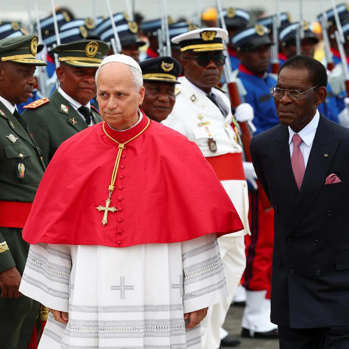 Pope Leo XIV walks next to President of Equatorial Guinea Teodoro Obiang Nguema Mbasogo upon his arrival at Malabo International Airport on April 21.