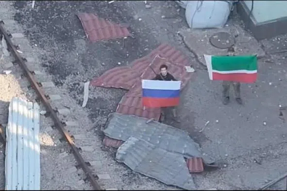 A drone view on July 3 showing soldiers holding up a Russian and Chechen Republic flags as the Russian forces reportedly took control of Kostiantynivka in the Donetsk region, Ukraine.