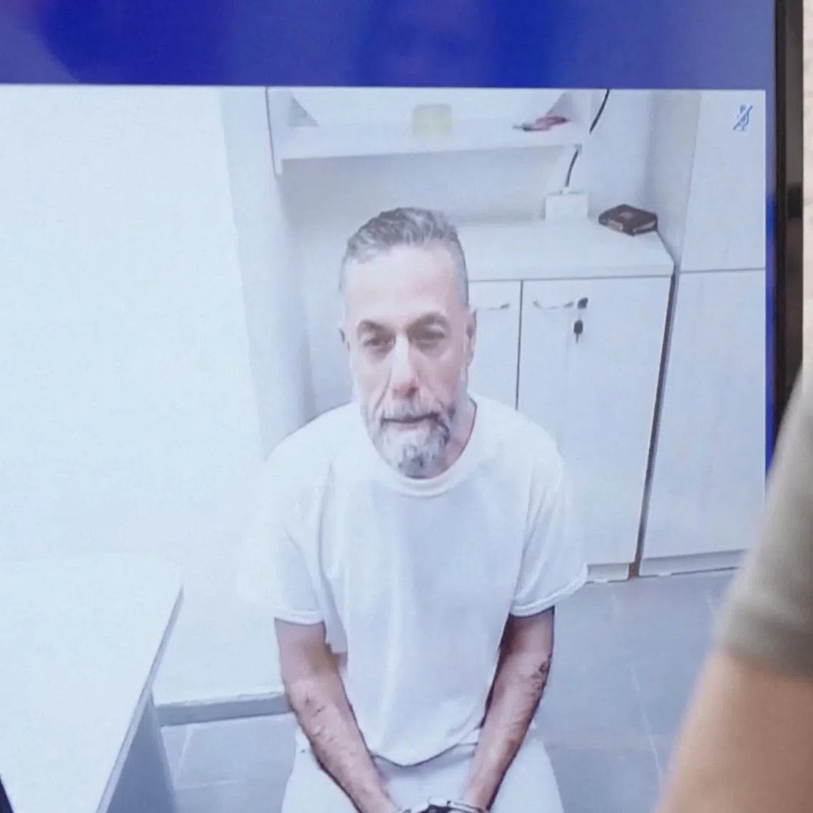 Palestinian doctor Hussam Abu Safiya, who was captured by the Israeli military in Gaza in late 2024 and still held in detention, appears via video link at the Israeli Supreme Court hearing in Jerusalem, June 10, 2026. REUTERS TV via REUTERS