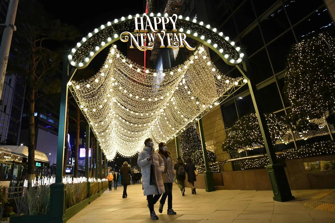 People visit a shopping district on New Year's Eve in Seoul on Dec 31, 2020.