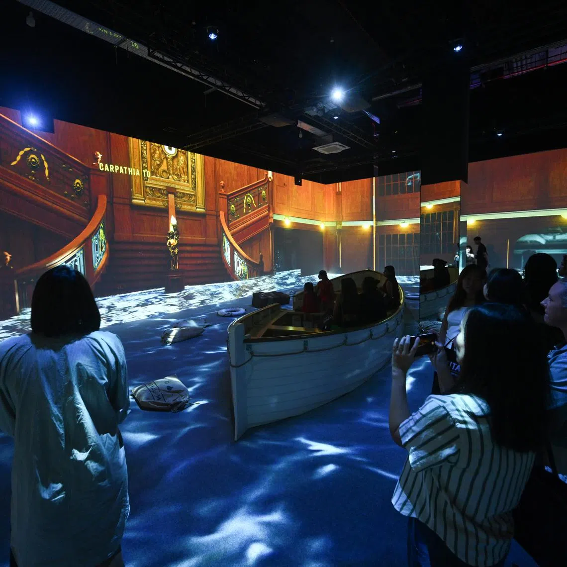 Participants in Titanic: An Immersive Voyage — Through the Eyes of the Passengers are taken through the doomed ship's final moments through projected visuals and audio.