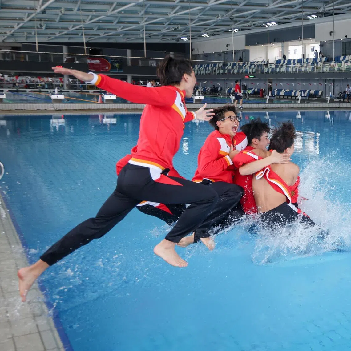 Singapore Sports School players and coach Rio Shirahama celebrate after SSP-OSS defeated ACS (Independent) in the National School Games B Div Boys' Water Polo Final At Our Tampines Hub on March 30, 2026. 