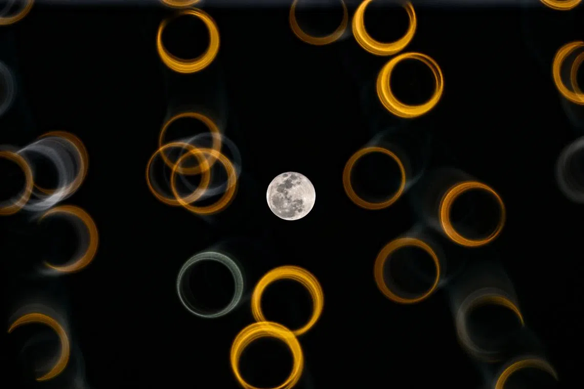 Harvest moon among LED decorative lights along Pagoda Street in Chinatown on Sept 18, 2024.  