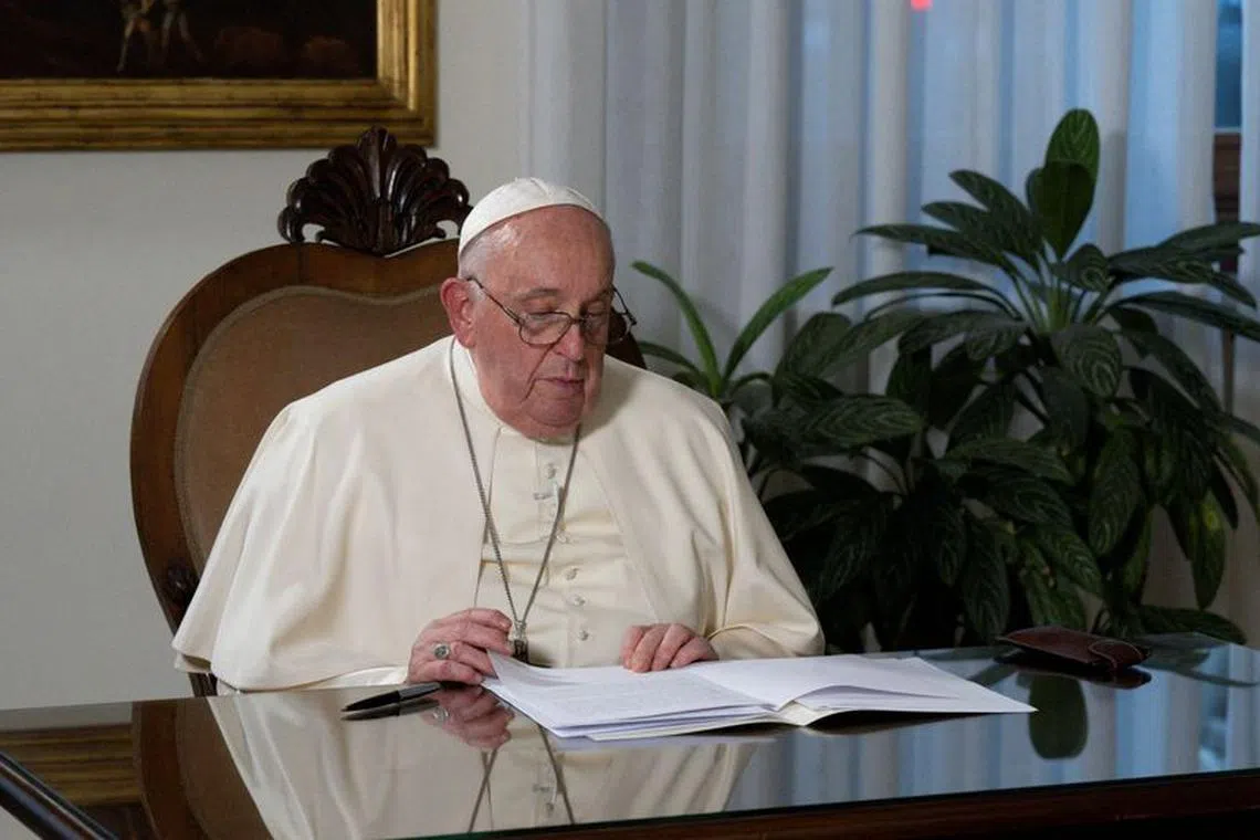 FILE PHOTO: Pope Francis records a video message to be broadcasted during the inauguration of the \"Faith Pavilion\" during COP28 in Dubai, at Casa Santa Marta in the Vatican in this handout image released on December 3, 2023.  Vatican Media/­Handout via REUTERS/File Photo