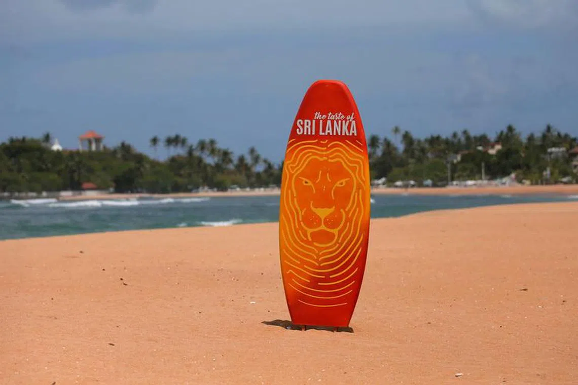 FILE PHOTO: A surfboard is seen in the middle of an empty beach, near hotels at Unawatuna beach in Galle, Sri Lanka July 4, 2019. Picture taken July 4, 2019. REUTERS/Dinuka Liyanawatte/File Photo