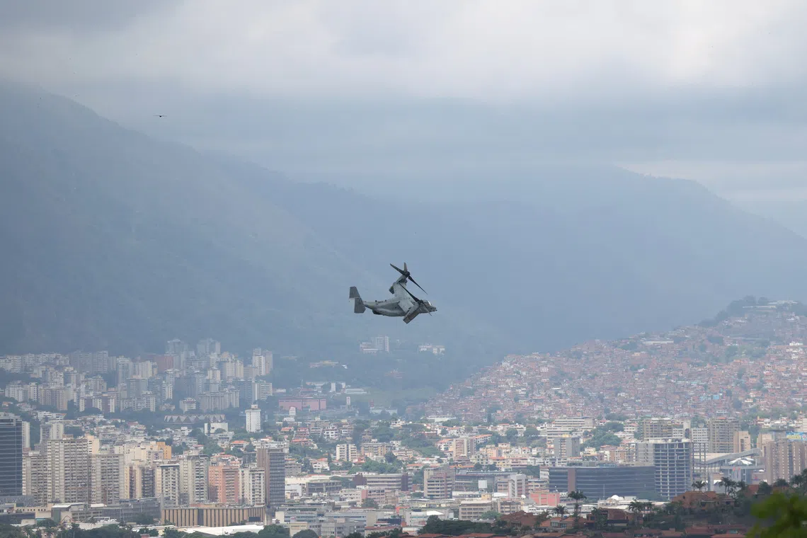 FILE PHOTO: A U.S. Marine Corps MV-22B Osprey aircraft flies away from the U.S. embassy and overflies the city during a military exercise, in Caracas, Venezuela, May 23, 2026. REUTERS/Leonardo Fernandez Viloria/File Photo