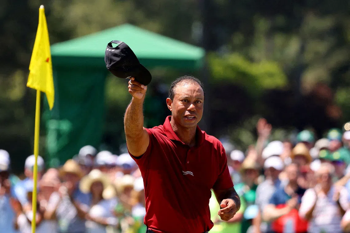 FILE PHOTO: Golf - The Masters - Augusta National Golf Club, Augusta, Georgia, U.S. - April 14, 2024 Tiger Woods of the U.S. acknowledges the crowd on the green on the 18th hole after completing his final round REUTERS/Mike Blake/File Photo