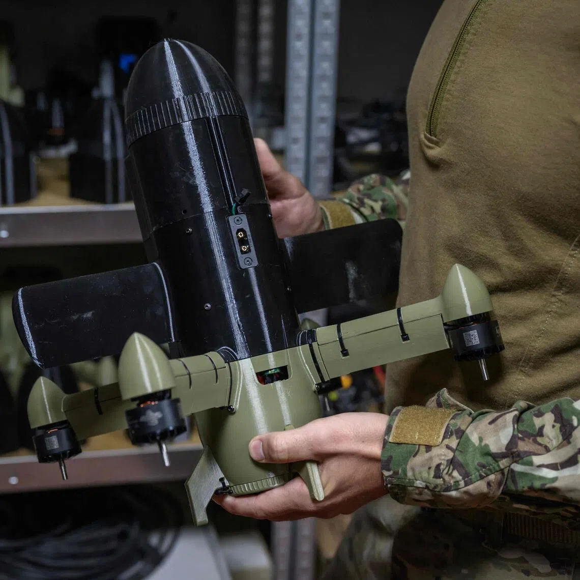 A Ukrainian service member holding an interceptor drone that Ukraine uses to  neutralise the Iranian-designed Shahed drones that Russia fires at Ukraine.
