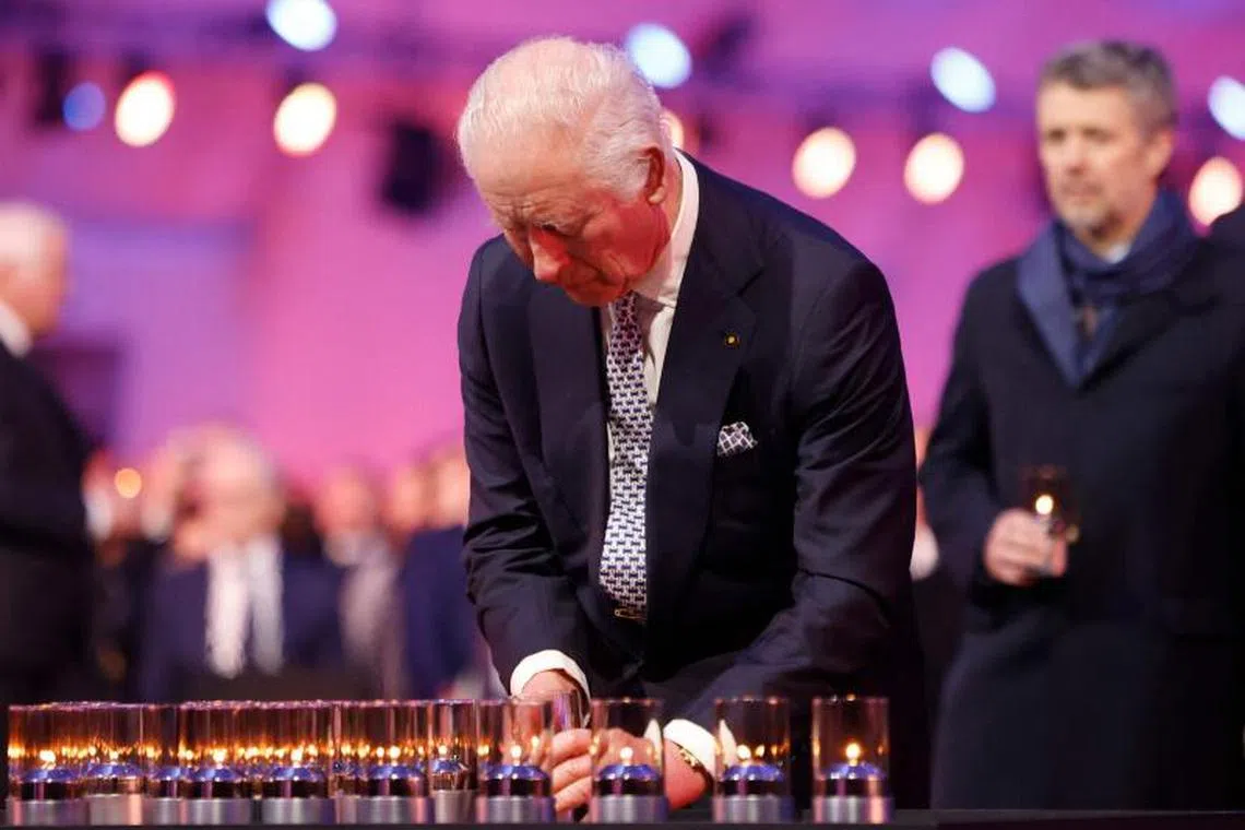 Britain’s King Charles III lays a candle during the commemorations on the 80th anniversary of the liberation of the German Nazi concentration and extermination camp Auschwitz-Birkenau by the Red Army, in Oswiecim, Poland on January 27, 2025. (Photo by Wojtek RADWANSKI / AFP)