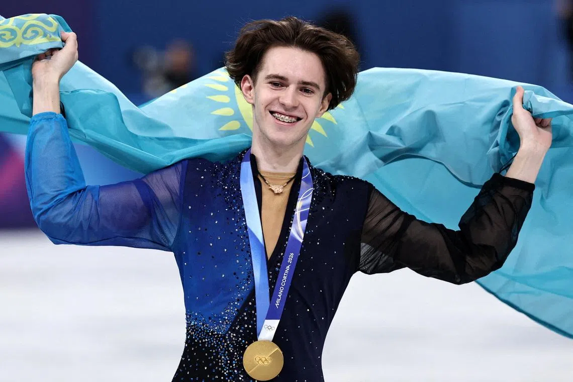 Milano Cortina 2026 Olympics - Figure Skating - Men Single Skating - Victory Ceremony - Milano Ice Skating Arena, Milan, Italy - February 13, 2026. Gold medallist Mikhail Shaidorov of Kazakhstan celebrates with his national flag after winning the Men Single Skating REUTERS/Amanda Perobelli