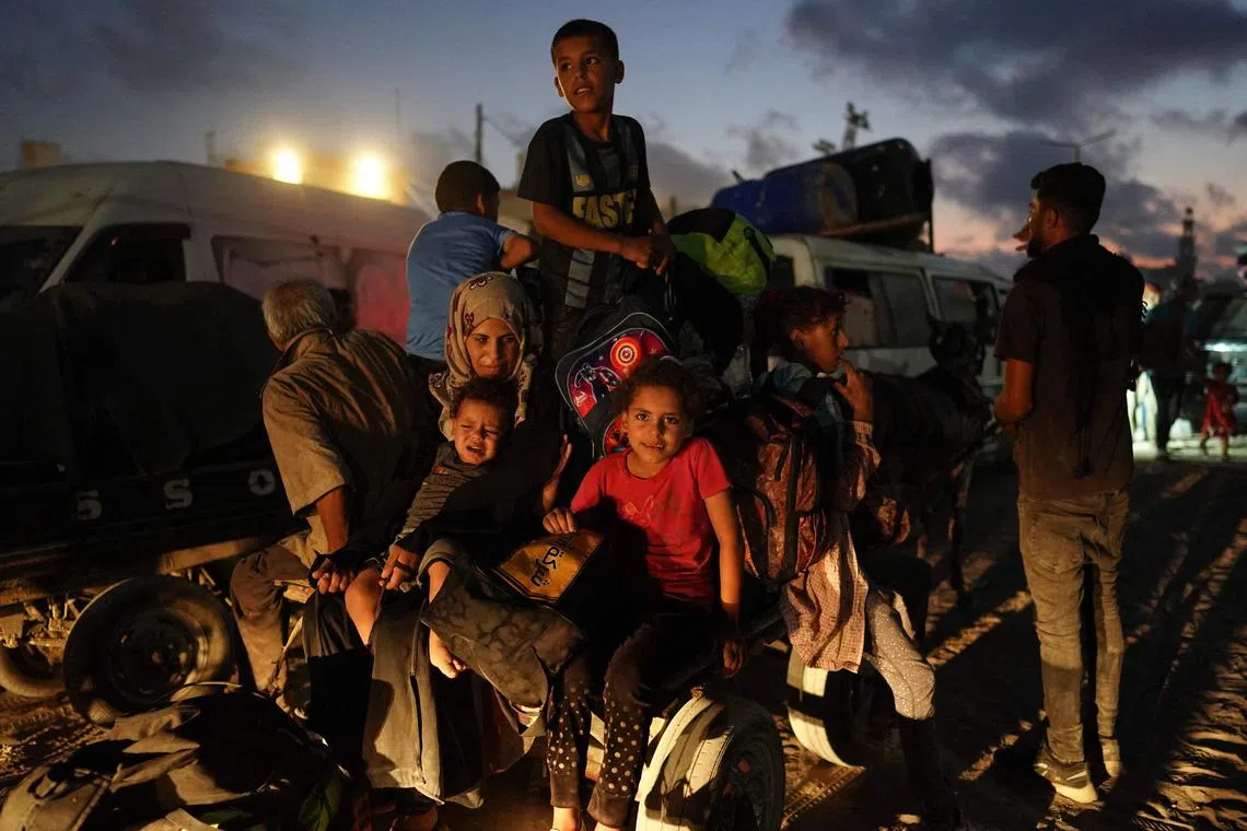 Displaced Palestinians leave an area in east Khan Yunis towards the west, after the Israeli army issued a new evacuation order for parts of the city, in the southern Gaza Strip on July 22.
