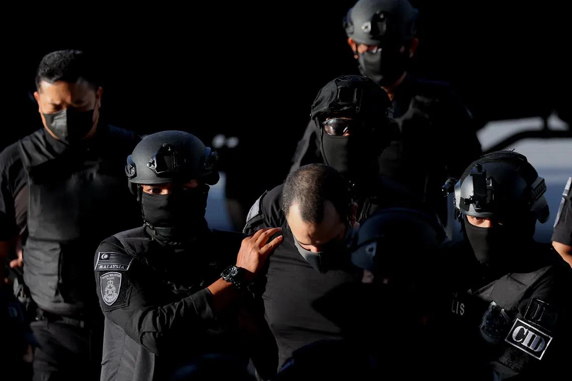 epa11274078 Israeli Shalom Avitan (C) is escorted by Royal Malaysia Police officers as they arrived at Kuala Lumpur Sessions Court, Kuala Lumpur, Malaysia, 12 April 2024. Shalom Avitan was initially detained at a hotel in Kuala Lumpur on 27 March with six handguns including a Glock 19 Marine, Glock 17 Gen 4, Smith and Wesson, Sig Sauer and Stoeger and 200 rounds of ammunition in his possession.  EPA-EFE/FAZRY ISMAIL