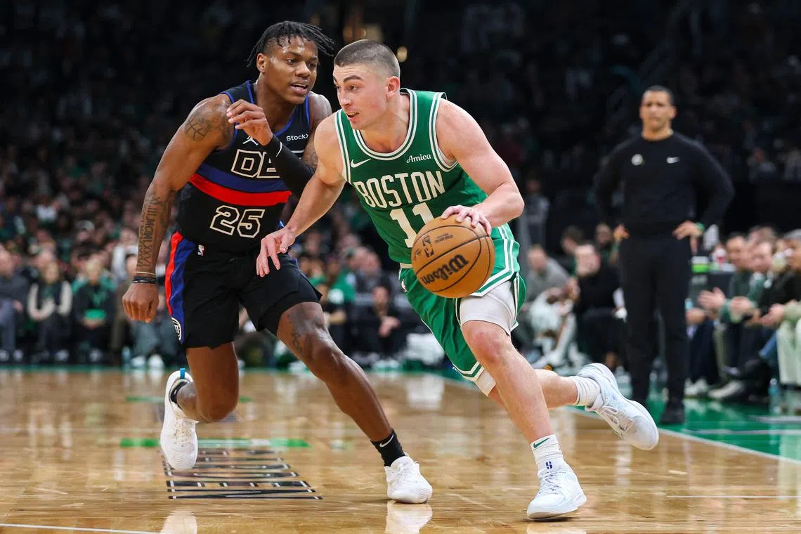Payton Pritchard of the Boston Celtics goes to the basket while guarded by Marcus Sasser of the Detroit Pistons during the third quarter at TD Garden.
