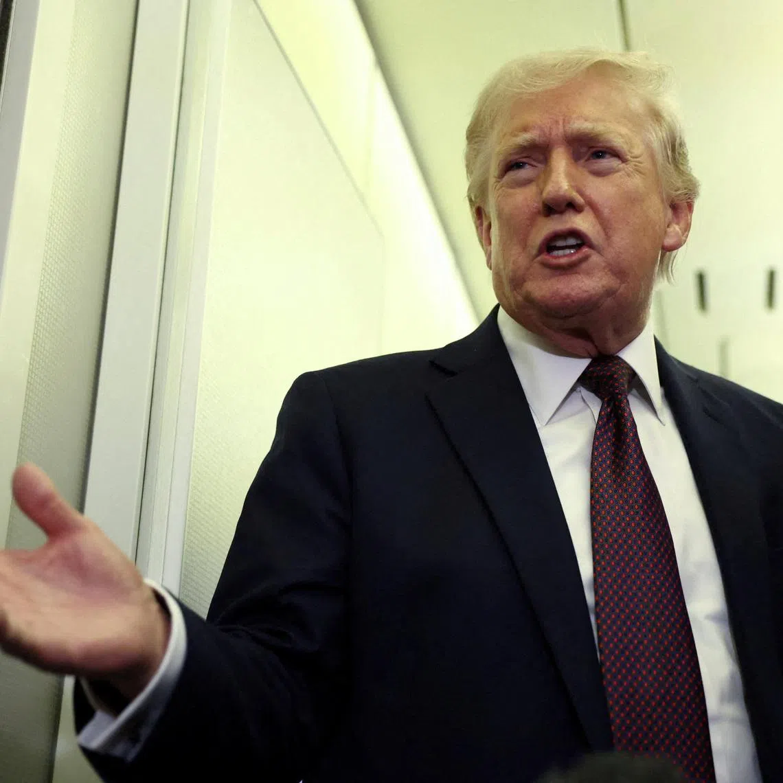 FILE PHOTO: U.S. President Donald Trump speaks to reporters aboard Air Force One on a flight back to Washington March 15, 2026. REUTERS/Kevin Lamarque/File Photo
