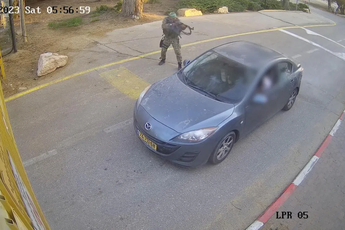 CCTV footage shows a Hamas militant firing upon a car while the occupants were waiting to enter the Be'eri kibbutz, in southern Israel.