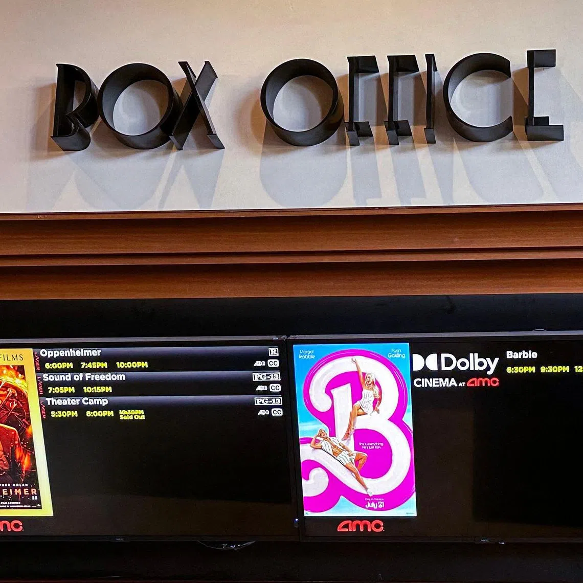 A movie theater Box Office is pictured announcing the opening of "Oppenheimer" and "Barbie" movies, in Los Angeles California, on July 20, 2023. "Oppenheimer" is facing off against "Barbie" in the biggest clash of Hollywood summer blockbusters, with both opening on the same day in a duel the media has dubbed "Barbenheimer". (Photo by VALERIE MACON / AFP)