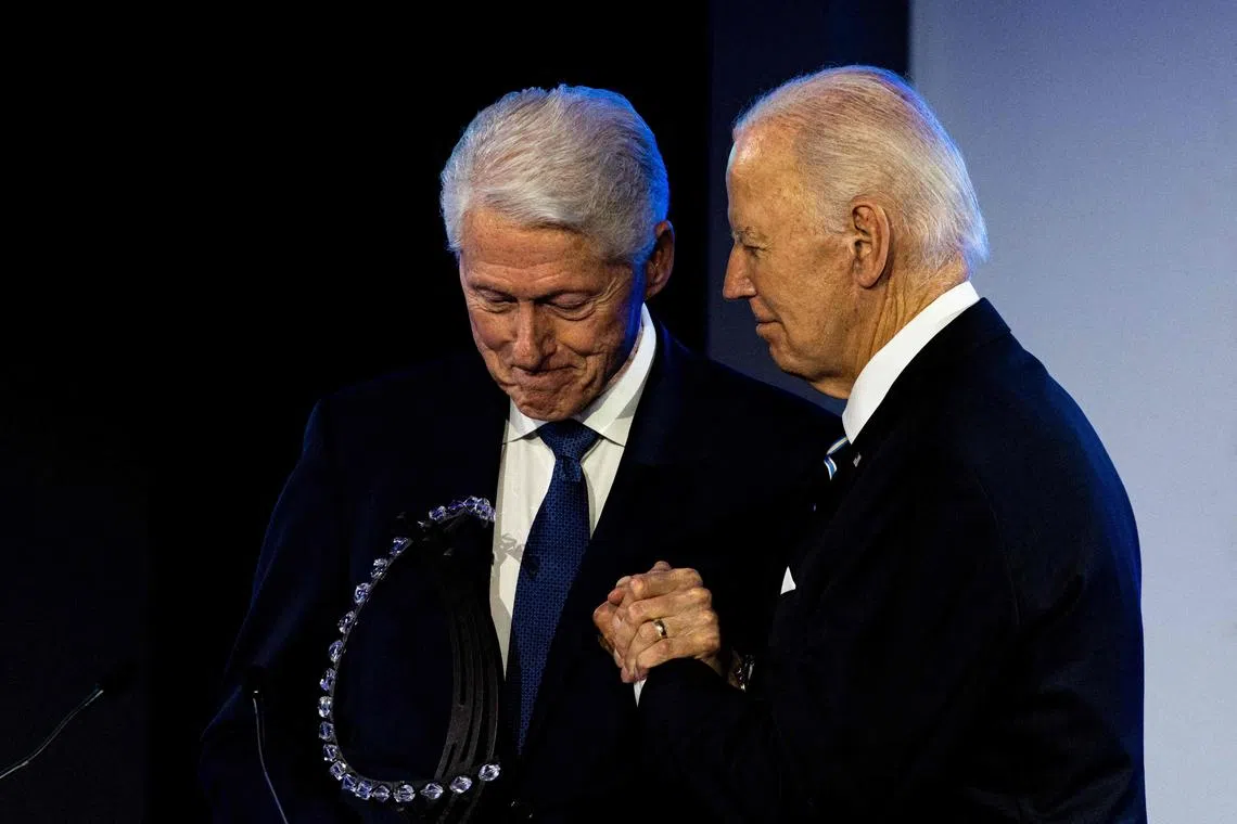 US President Joe Biden (right) and former president Bill Clinton meet in New York for a surprise ceremony honouring Mr Biden.