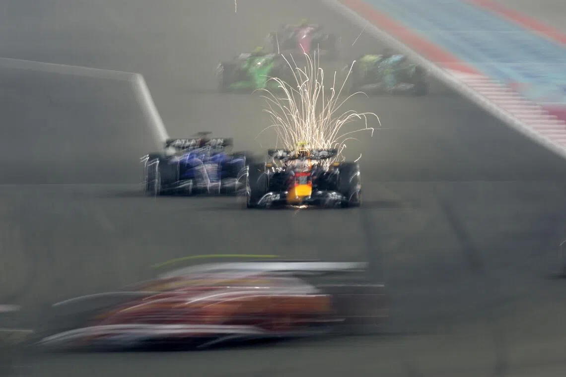 epa12560033 Red Bull Racing driver Yuki Tsunoda of Japan (R) competes in the Formula 1 Qatar Grand Prix at the Lusail International Circuit racetrack outside Doha, Qatar, 30 November 2025.  EPA/ALI HAIDER