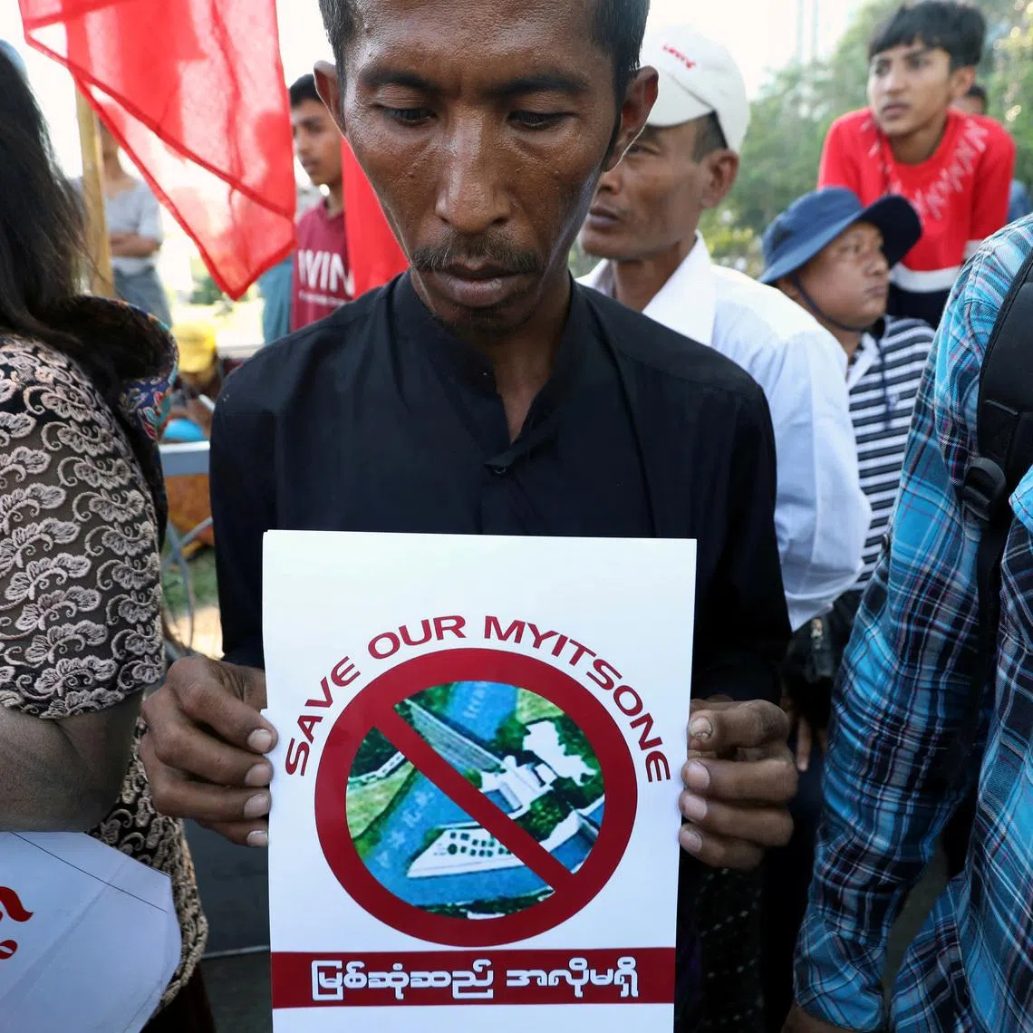 A protester holding a flyer against the Myitsone hydropower dam during the last day of Chinese President Xi Jinping’s visit in Yangon in January 2020.