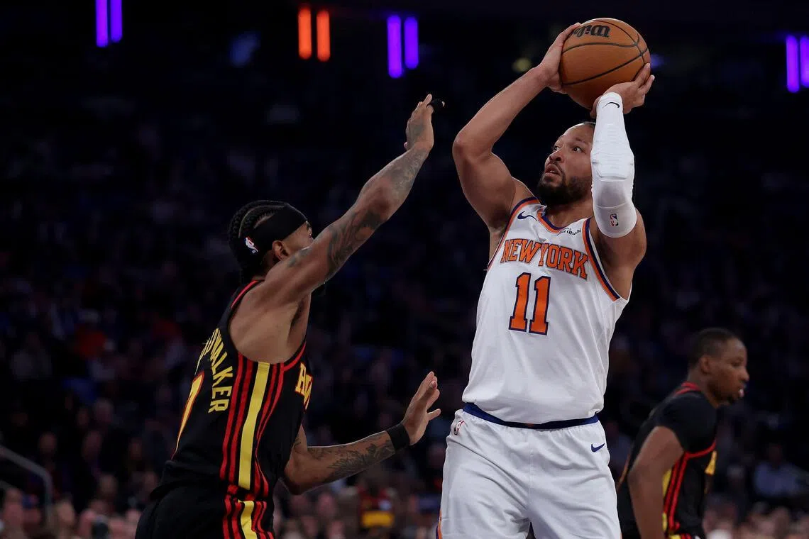 Jalen Brunson of the New York Knicks takes a shot as Nickeil Alexander-Walker of the Atlanta Hawks defends during the first half of Game One.