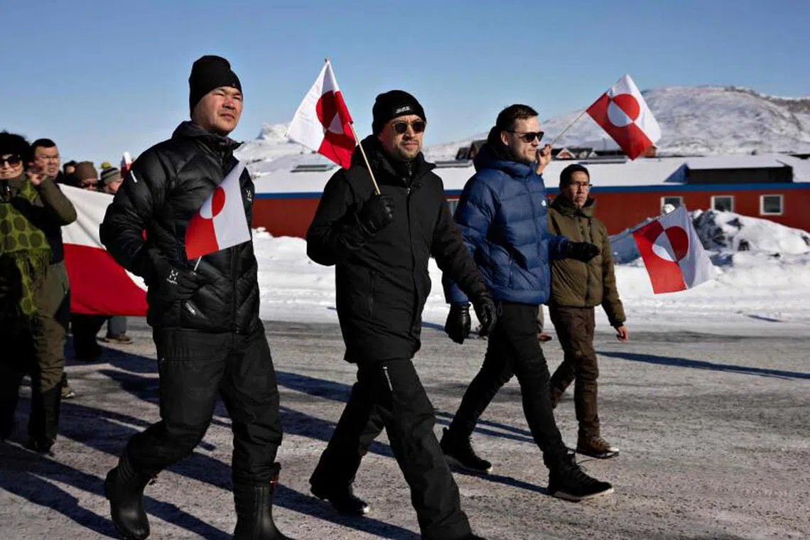 Greenland’s outgoing Prime Minister and head of the left green party Inuit Ataqatigiit (IA) Mute Bourup Egede (2L) and leader of Greenland’s centre-right Demokraatit party Jens Frederik Nielsen (2R) attend a march to the US consulate during a demonstration, under the slogan ‘Greenland belongs to the Greenlandic people’, in Nuuk, Greenland, on March 15, 2025. (Photo by Christian Klindt Soelbeck / Ritzau Scanpix / AFP) / Denmark OUT