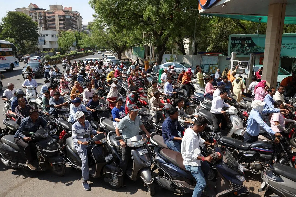 People queueing to fill petrol in their two-wheelers with concerns over potential supply disruptions, despite authorities saying there are no shortages, amid the ongoing US-Israeli conflict with Iran, in Ahmedabad, India, March 23.