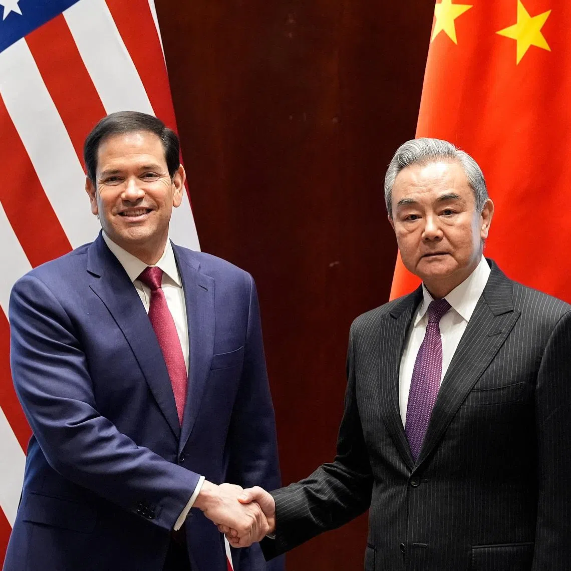 U.S. Secretary of State Marco Rubio shakes hands with China’s Foreign Minister Wang Yi in Munich, Germany, February 13, 2026, on the sidelines of the Munich Security Conference.     Alex Brandon/Pool via REUTERS