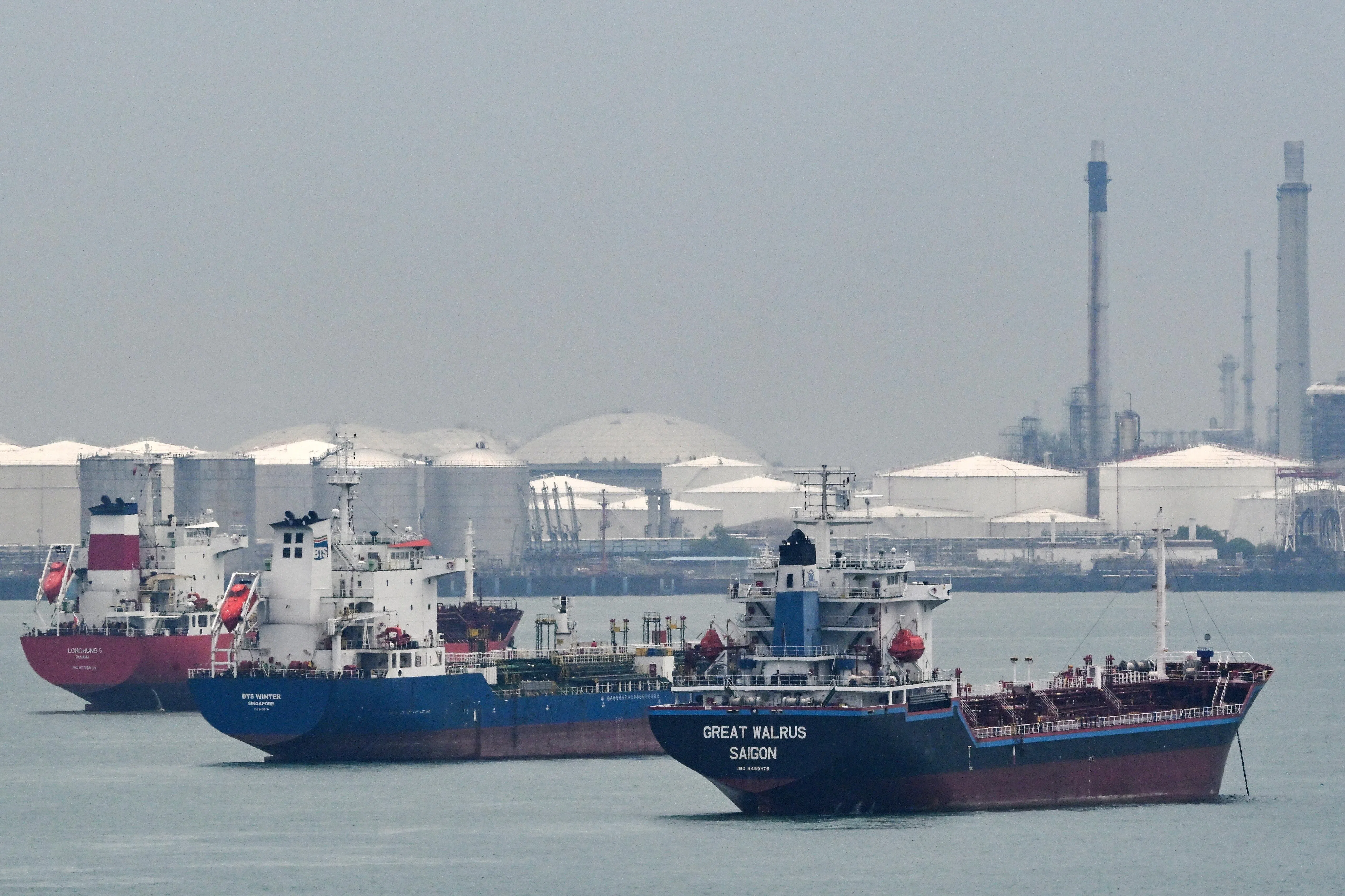 Image 7: Oil tankers (from right) Great Walrus, BTS Winter and Longhung 5 near the oil refinery at Pulau Bukom on April 26.