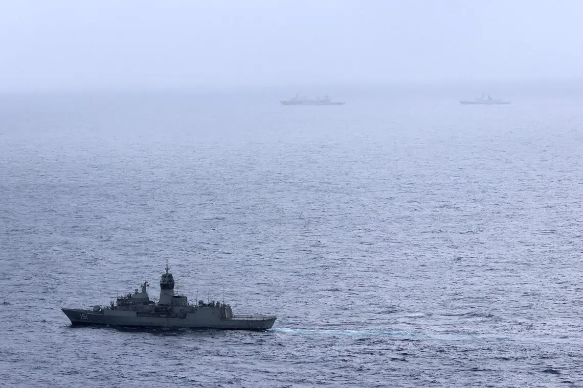 Royal Australian Navy ship HMAS Arunta (foreground) sailing near China's Fuchi-class replenishment vessel and Weishanhu Jiangkai-class frigate Hengyang in the Tasman Sea.