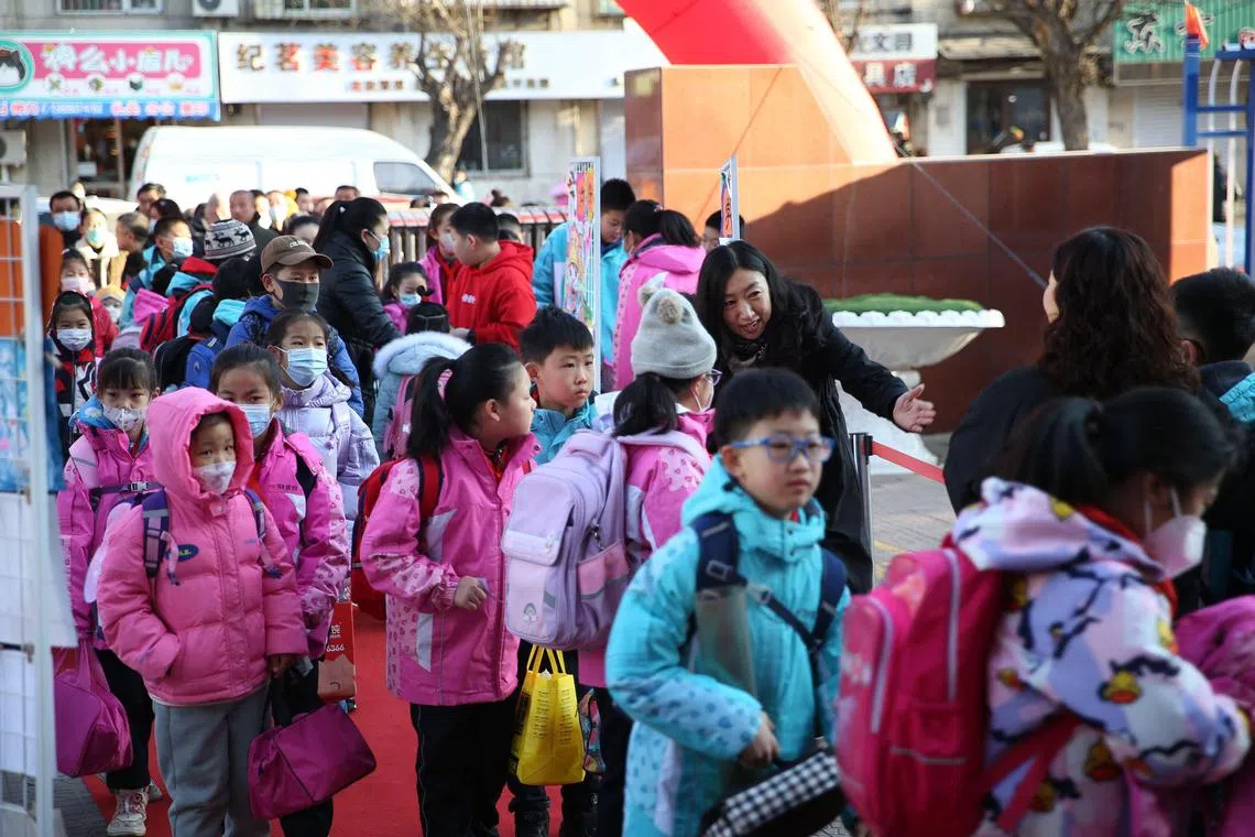Students arriving to school on the first day of the new semester in Shenyang on March 1, 2023.