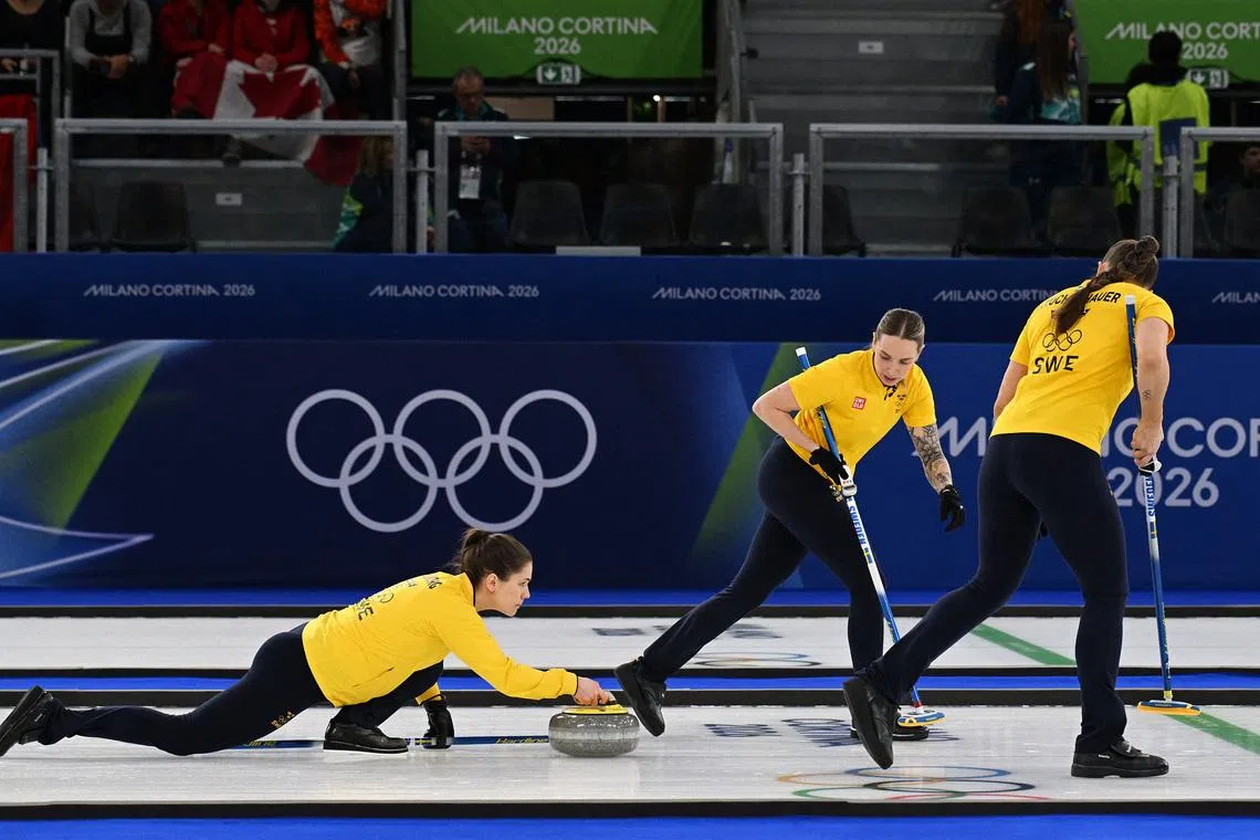 Milano Cortina 2026 Olympics - Curling - Women's Semi-final - Canada vs Sweden - Cortina Curling Olympic Stadium, Cortina d'Ampezzo, Italy - February 20, 2026. Anna Hasselborg of Sweden, Sofia Scharback of Sweden and Agnes Knochenhauer of Sweden in action during the match against Canada REUTERS/Jennifer Lorenzini