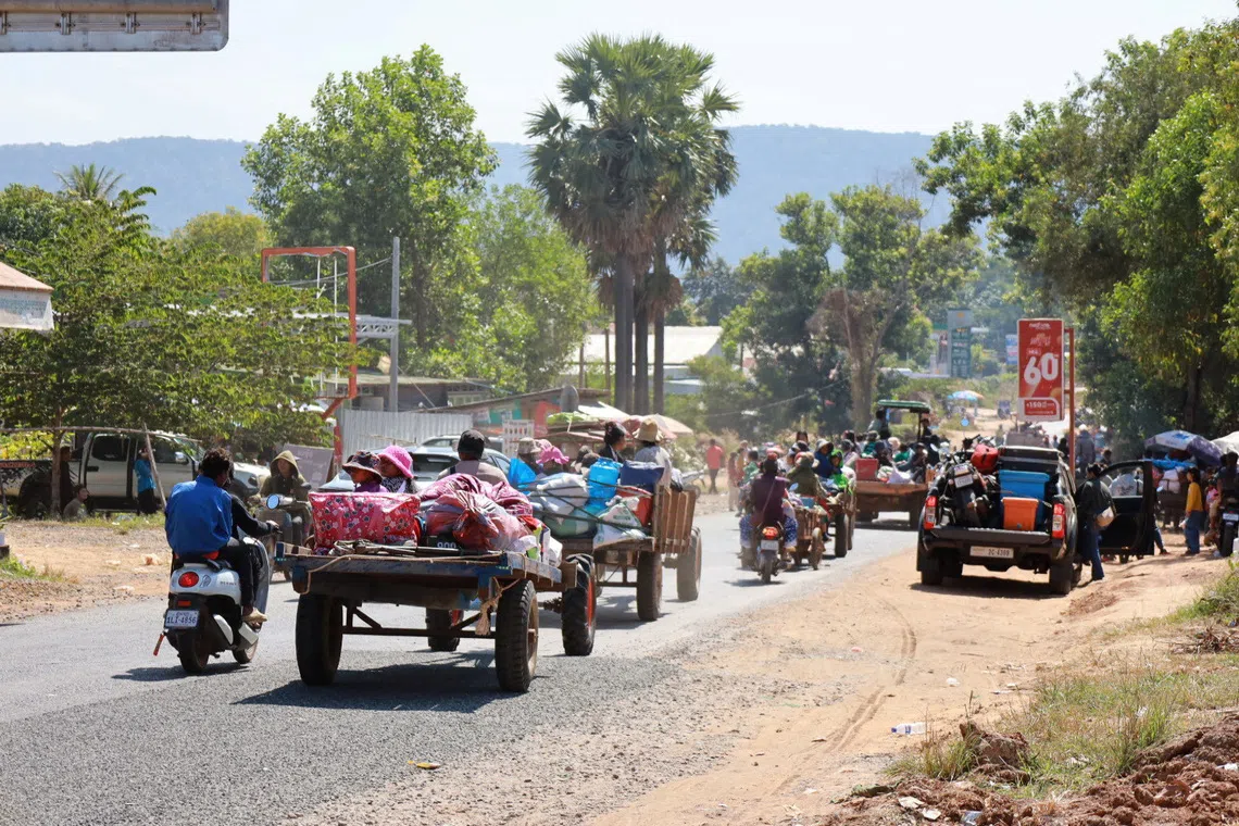 People flee amid clashes between Thailand and Cambodia along a disputed border area, in Oddar Meanchey Province, Cambodia, December 8, 2025. Agence Kampuchea Press/Handout via REUTERS