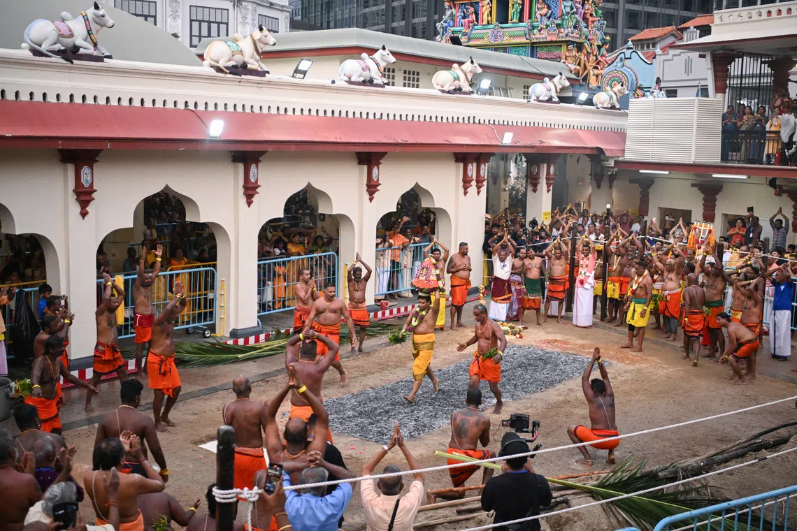 Head pandaram Venugopal Thirunavukarasu is the first to cross the fire pit shortly after 6.15pm at Sri Mariamman Temple during the annual fire walking festival on Oct 12. 