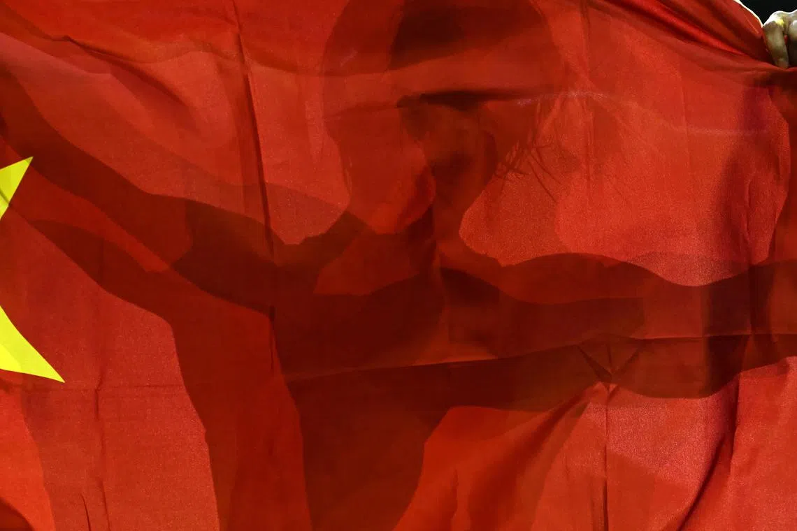 Qi Zhang of China celebrating with the national flag after she defeated Yuliia Tkach of Ukraine in the final of women's 59kg category of the Wrestling World Championships in Belgrade, Serbia on Sept 19.