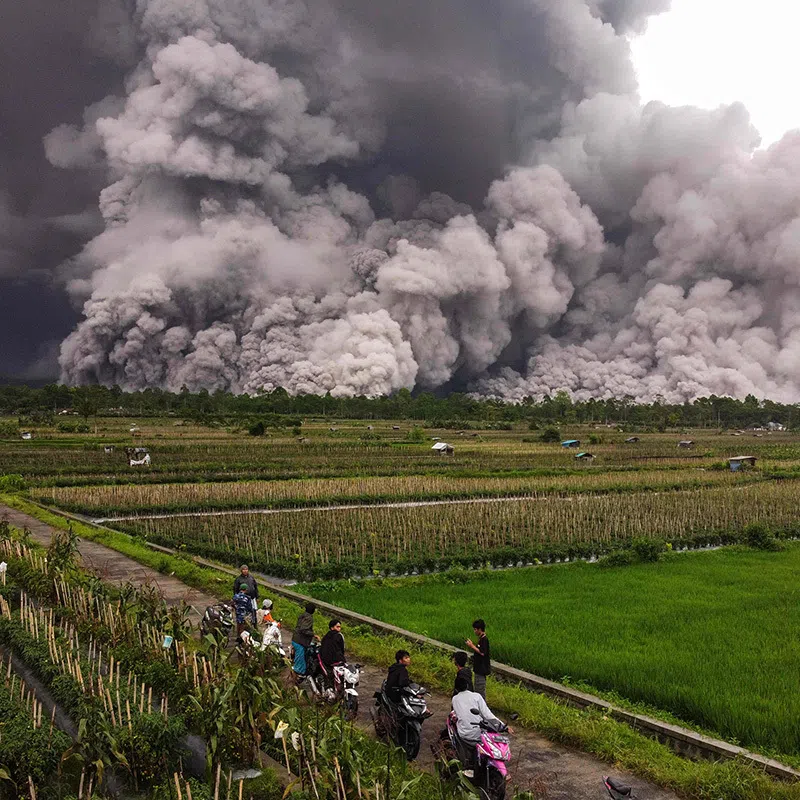 An aerial picture shows a pyroclastic flow during the eruption of Mount Semeru in Lumajang, East Java, on November 19, 2025. (Photo by Agus Harianto / AFP)