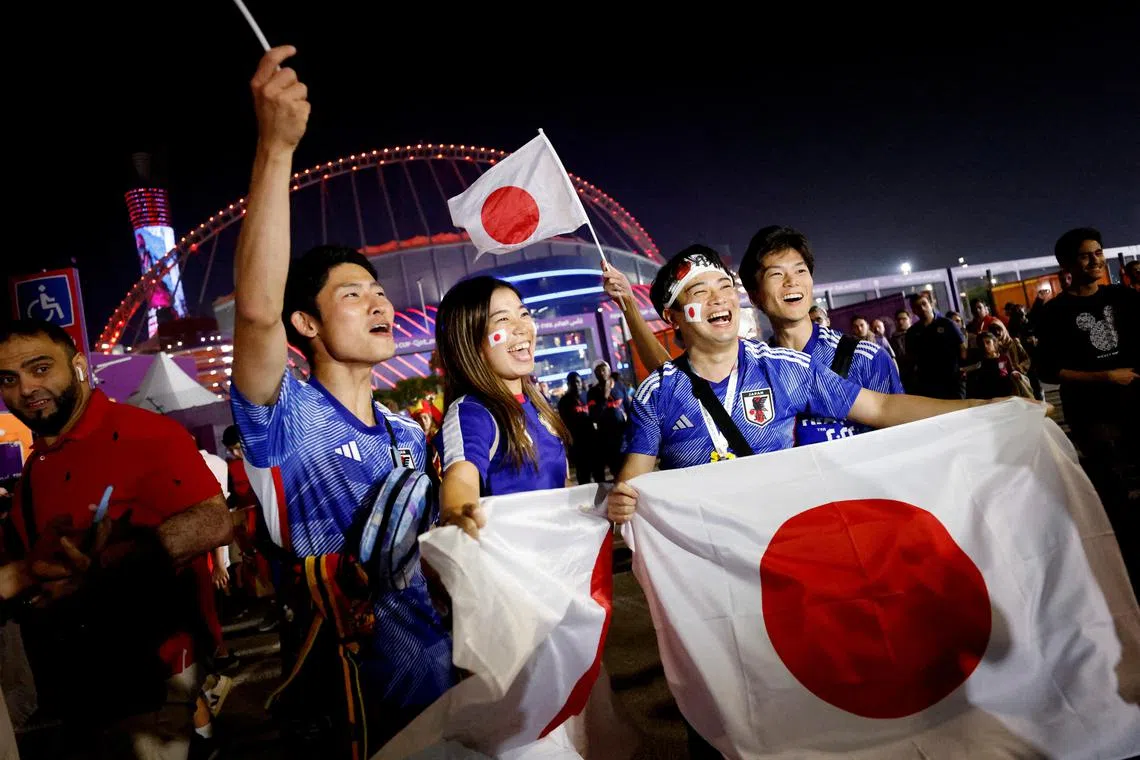Japan fans celebrating after Japan beat Spain, outside the Khalifa International Stadium in Doha  on Dec 1.