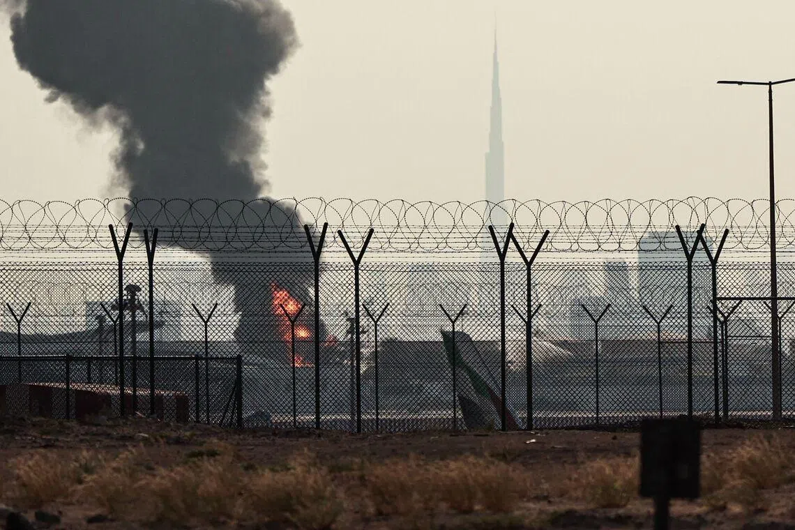 A smoke plume rises from an ongoing fire near Dubai International Airport on March 16.