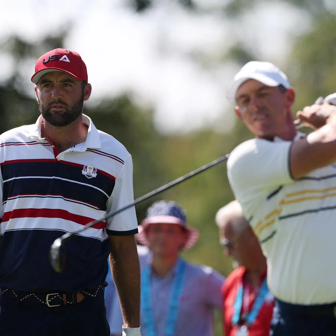 Golf - The 2025 Ryder Cup - Bethpage Black Golf Course, Farmingdale, New York, United States - September 28, 2025 Team Europe's Rory McIlroy hits his tee shot on the 2nd hole during the singles as Team USA's Scottie Scheffler looks on REUTERS/Paul Childs/File Photo