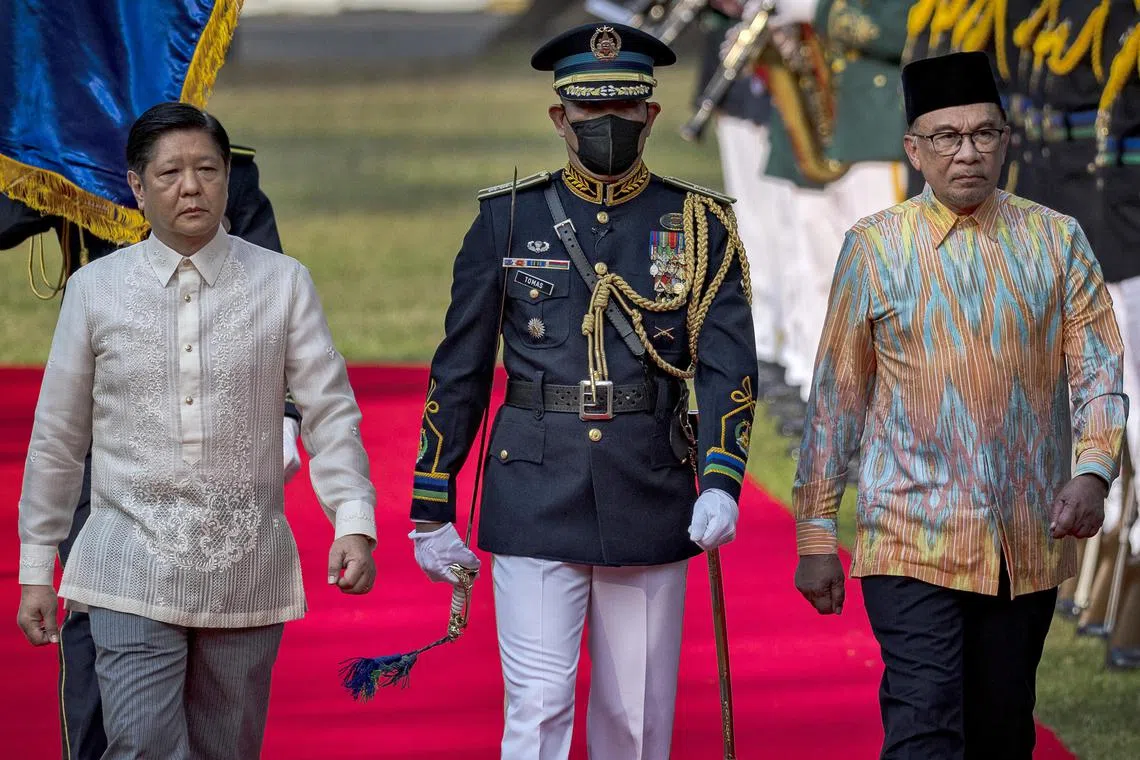 Malaysian Prime Minister Anwar Ibrahim and Philippine President Ferdinand Marcos Jr. review honor guards during a welcome ceremony at Malacanang Palace on March 01, 2023 in Manila, Philippines. 