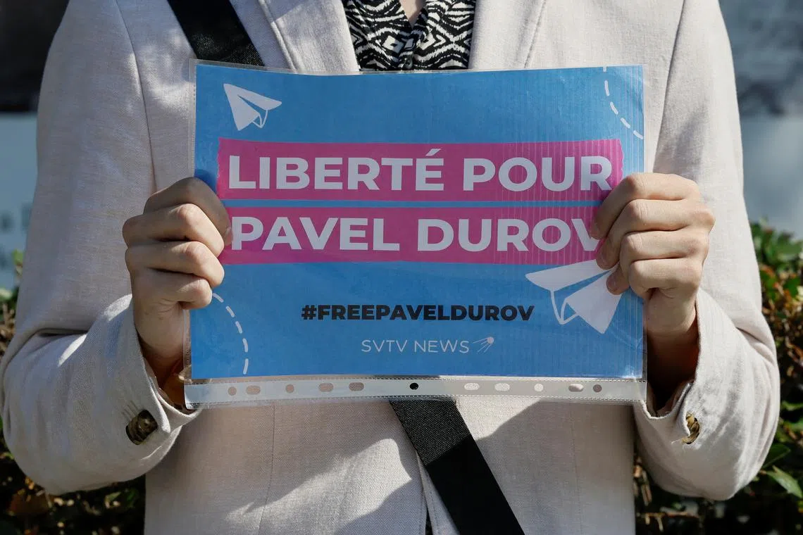 FILE PHOTO: A participant of a one-person picket demonstrates a placard to bring attention to the arrest of Pavel Durov, founder and CEO of the Telegram messaging app, near the French embassy in Moscow, Russia August 25, 2024. A slogan on the placard reads: \"Freedom for Pavel Durov\". REUTERS/Yulia Morozova/File Photo