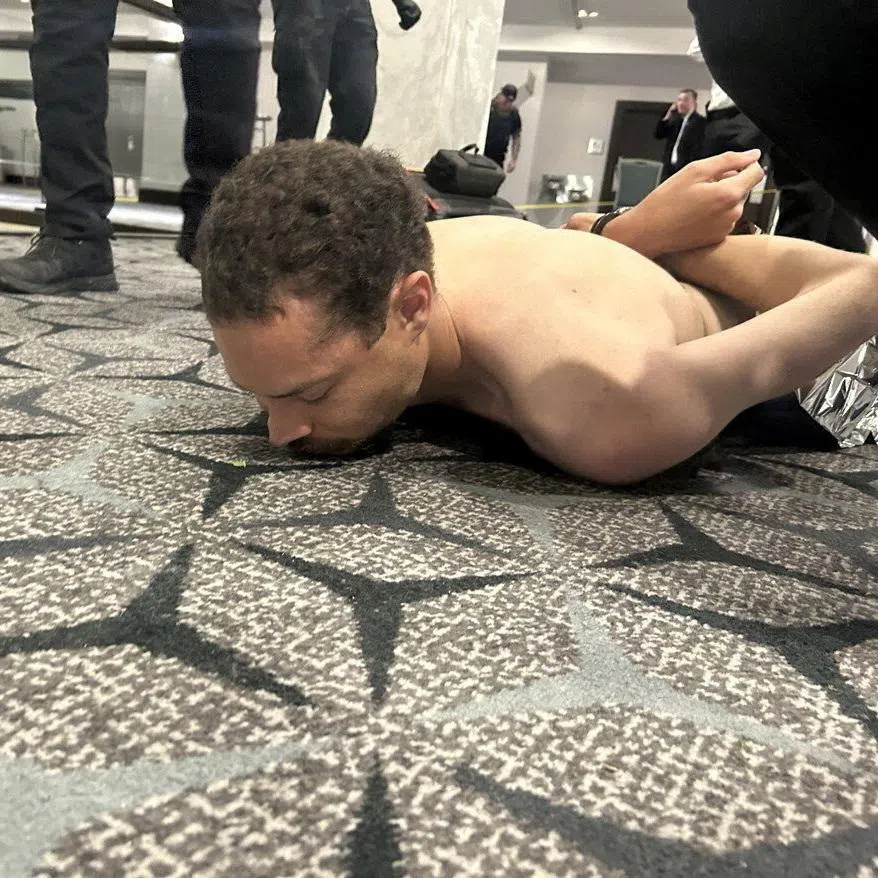 Law enforcement personnel detaining Cole Tomas Allen, a suspect in the shooting incident at the White House Correspondents' Association dinner, on April 25.